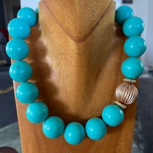 Turquoise colored large beads with gold plated accents and closure.